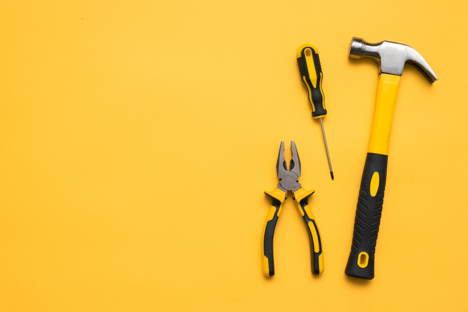 Construction tools on the yellow flat lay background with copy s